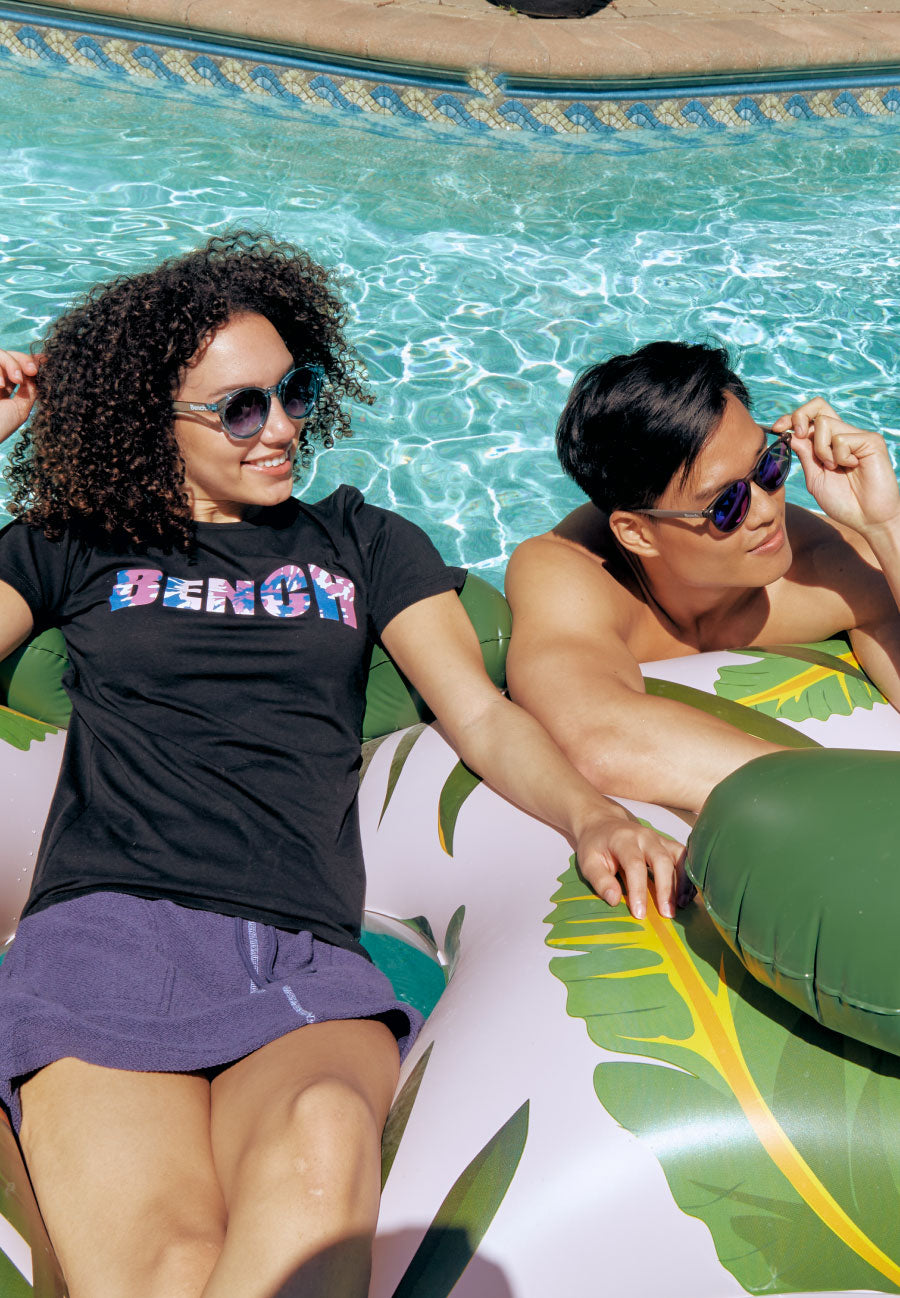 Bench contemporary athleisure clothing | pool outfit | Men boat shorts, women summer tee